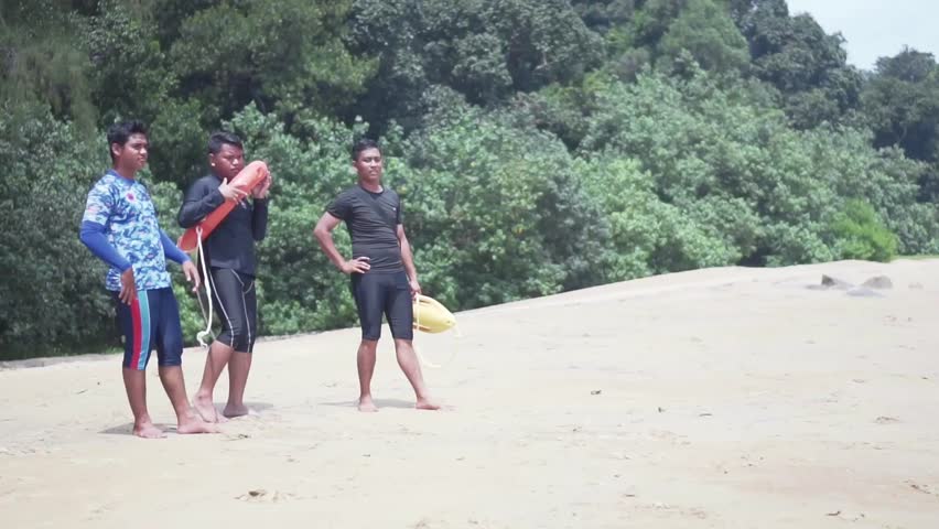 Three Asian Lifeguards Watching On The Beach