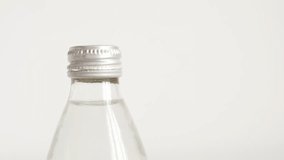 Slow motion opening glass bottle with fingers close-up footage
