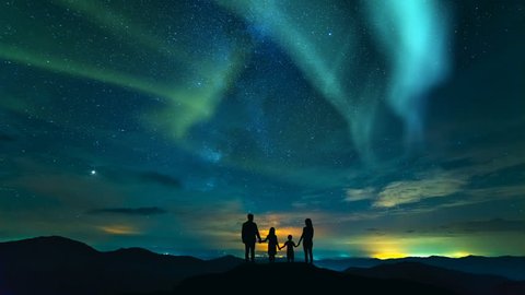 The family standing on a background of a city with a northern light. time lapse
