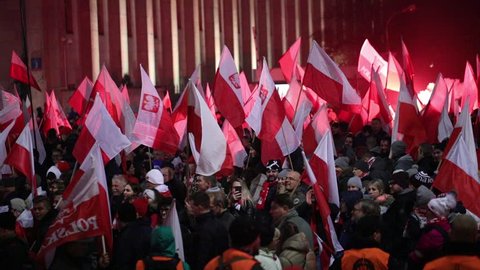 Warsaw / Poland - 11.11.2018: The Independece March. nationalists faces flags and symbols. National Independence Day 100th anniversary.