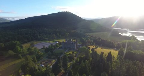 Drone Footage of Morning in a Scottish Countryside Featuring Sun Beams on the Right - Inveraray Castle
