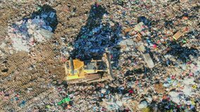 City Dump, The Bulldozer Moves garbage Along the Landfill, Leveling the rubish. AERIAL, Top Vew - Powered by Shutterstock - Get 15% off with code: PIKWIZARD15