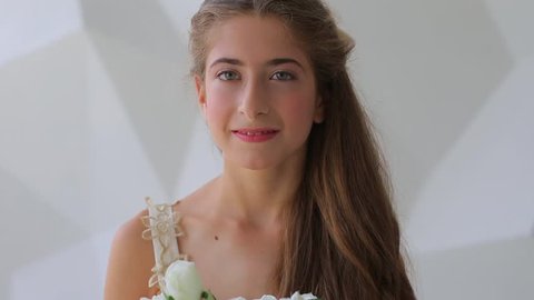 Self-confidence portrait of a happy smiling bat mitzvah girl on a white background. 
Strong Jewish pride concept.