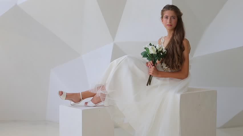 Pre-teen girl posing on a white background in dress with flowers.
Ways of honoring and celebrating women concept. Bat Mitzvah Celebration Brings Joy and Unity to Local Jewish Community. Celebrates  Royalty-Free Stock Footage #1019388772