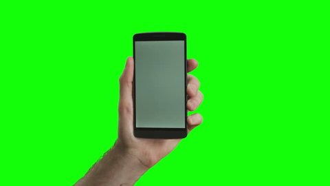 Hand holding the new smartphone on green screen. Extremely high quality. 4K resolution. The newest phone model. You can track it easily putting the trackers on the screen corners. 