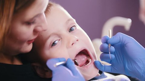 Dentistry. Dentist examines the oral cavity of the kid.