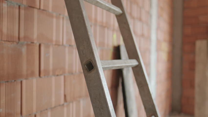 Confident people working in construction site. Portrait of happy hispanic man at work in new house inside apartment building. Professional latino worker using ladder and smiling at camera. Slow motion Royalty-Free Stock Footage #1019418415