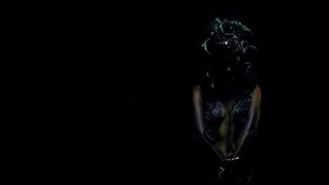 Gorgon Medusa swinging her swords, black background