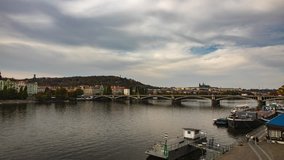 City view from bridge and traditional Czech architecture of antique Prague buildings at autumn evening. 4K Time Lapse.