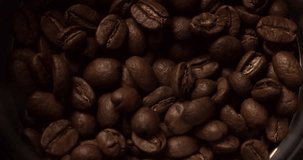 Coffee mill grinder grinds coffee beans extremely close up macro shot Slow Motion top view video