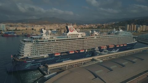 MALAGA, SPAIN - SEPTEMBER 27, 2018. Aerial view of docked Mein Schiff 5 cruise ship against cityscape