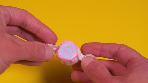 Opening a Piece of Taffy Candy