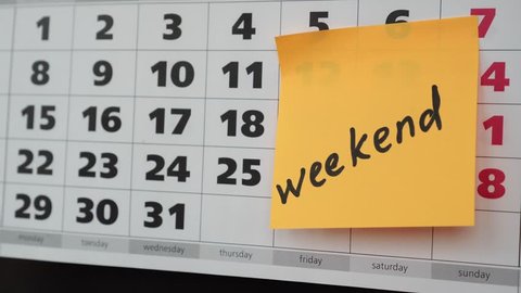 The concept of the weekend, office calendar, weekend inscription on the sticker.