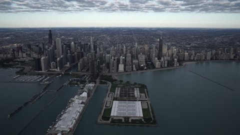 Chicago Circa-2015, high altitude wide aerial view flying over Lake Michigan looking towards the downtown core city skyline featuring Jardine Water Purification Plant and Navy Pier