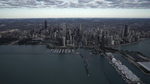 Chicago Circa-2015, high altitude wide aerial view flying over Lake Michigan looking towards the downtown core city skyline featuring Monroe Harbor