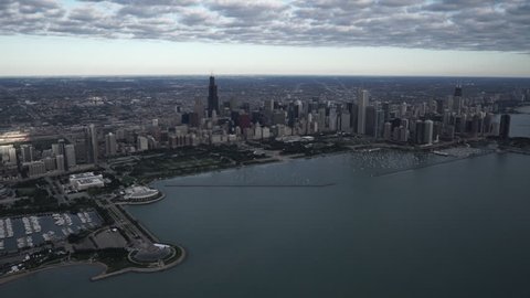 Chicago high altitude wide aerial view flying over Lake Michigan looking towards the downtown core city skyline featuring Monroe Harbour