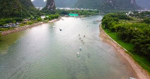 Tourists cruising on Li River in Yangshuo, China aerial view