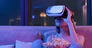 Young woman wear VR headset and touch virtual screen at night