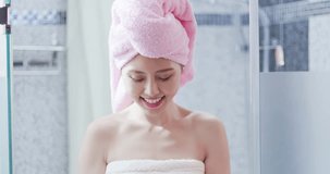woman with facial Cleansing foam in the bathroom after shower