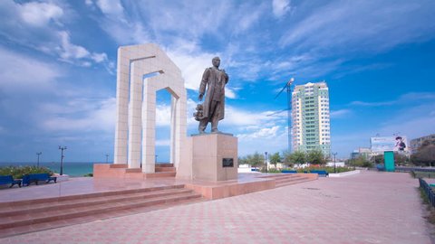 AKTAU, KAZAKHSTAN - CIRCA SEPTEMBER 2017: Monument to Zhalau Mynbayev in Aktau timelapse hyperlapse. Caspian sea on a background. Blue cloudy sky at summer day. Kazakhstan.