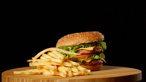 Craft beef burger and french fries, sauce isolated on black background. fast food