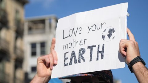 "Love your Mother Earth" Poster on a Demonstration due to Climate Change. Activism against capitalism. Strong message on a march. 