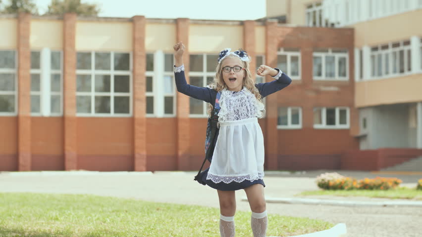 Russian 13 year old schoolgirl in a good mood with a backpack.