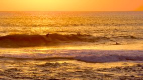 4k Surfing Sunset Waves and Amazing Landscape Ocean. Orange Surfer Beach. Sun rays in Colorful Sunset Waves. Beautiful Sky, Water Sunset Video. Clear Tropical Island View and Sunset Beach Background.