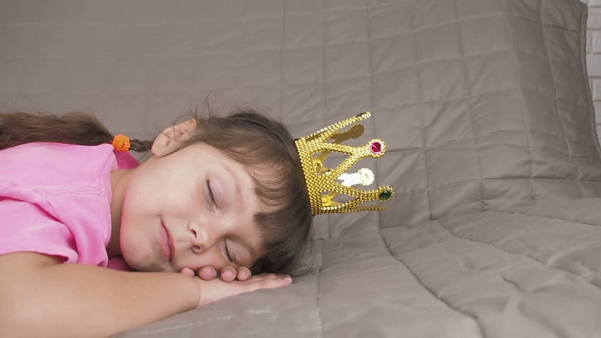 Sleeping princess. Charming little girl sleeping in the crown.