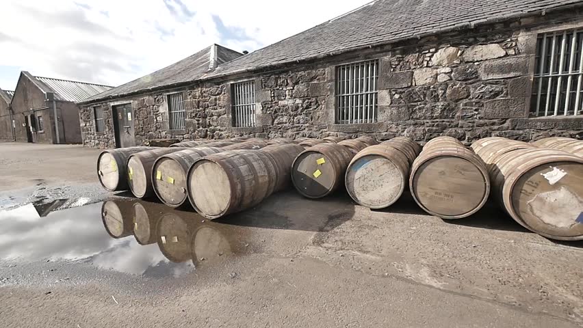 Outside of a Scottish Whiskey Distillery Featuring Stone Buildings and Aging Barrels