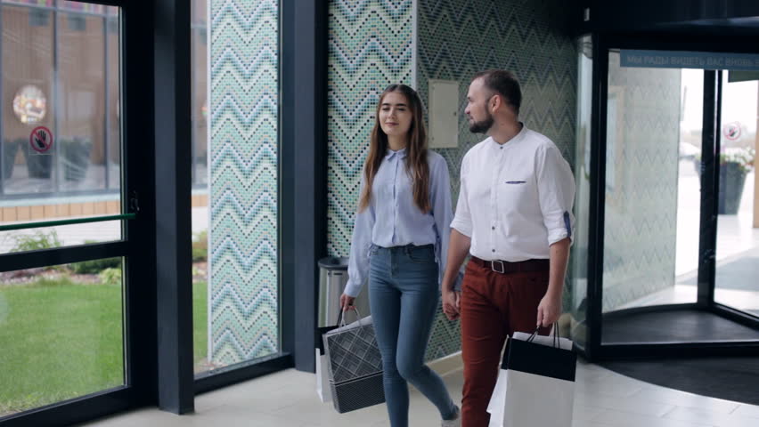 Couple walking through the mall. shopping theme