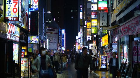 TOKYO, JAPAN - APRIL 2, 2012 Time Lapse Tokyo City Crowd of Shoppers People Visit Shopping Street Night Light