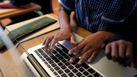 Close-up of African American schoolkids using laptop in classroom at school  - Powered by Shutterstock - Get 15% off with code: PIKWIZARD15