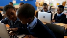 Side view of African American students using laptop in the classroom at school  - Powered by Shutterstock - Get 15% off with code: PIKWIZARD15