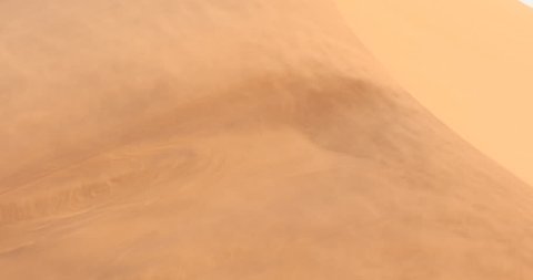 Red orange sand dune wave patterns with wind blowing sand over the dune, Sossusvlei, Namibia. Strong wind in the sand desert, pour. Landscape in Africa.
