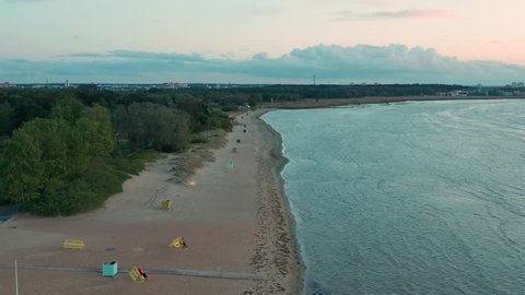 Aerial shot of an empty beach after sunset with changing cabins and benches. Stroomi / Pelguranna beach in Tallinn