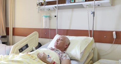 Cancer patient lying in hospital bed