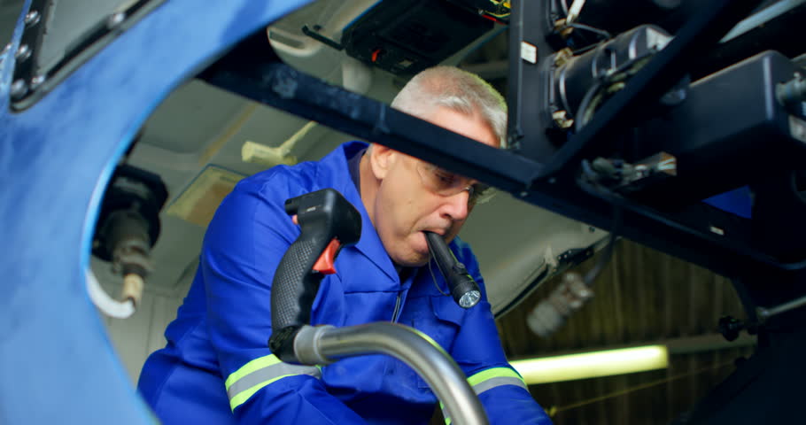 Male engineer repairing an aircraft in hangar