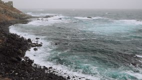 Big swells of the Atlantic ocean. Ocean waves rolling on the rocky coastline of Santo Antao Island. Cabo Verde, Cape Verde. 4K video footage