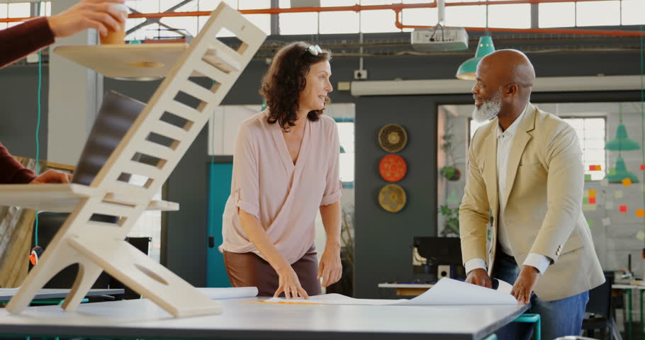Smiling diverse executives talking with each other in the office 4k