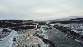 Aerial Drone Video of a icy blue river with snow-covered landscape in Husafell, Iceland Part 2
