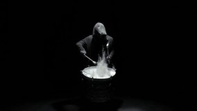 hooded man beats drum with flour