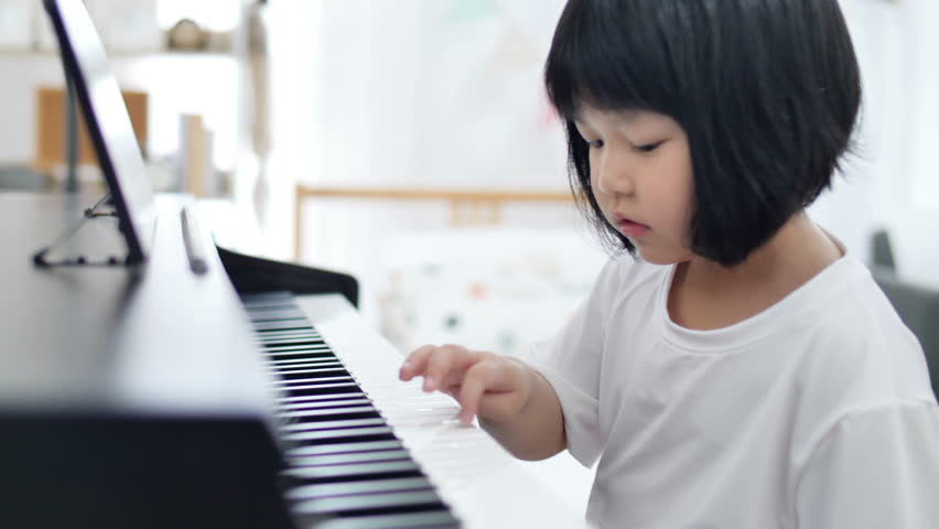 Happy Little Asian Girl Playing Piano Stock Photo (Edit Now) 1233916039