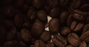 Coffee grinder mill start to grind coffee beans close up macro shot Slow Motion top view video
