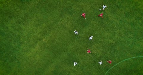 Aerial Top Down View of Soccer Field and Two Professional Teams Playing. Energetic Game in the Middle of the Field. Important Match on International Championship
