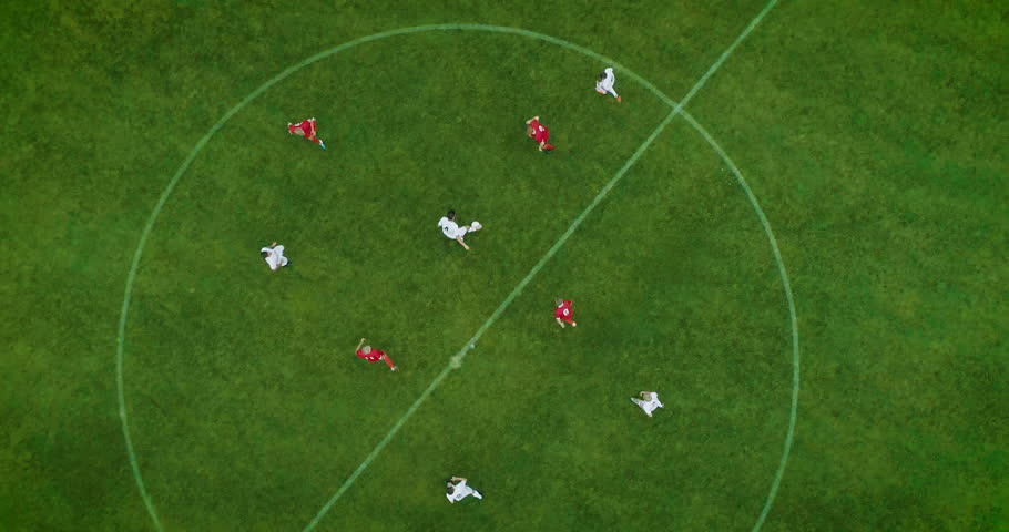 Aerial Top Down View of Soccer Field and Two Professional Teams Playing. Energetic Game in the Middle of the Field. Important Match on International Championship