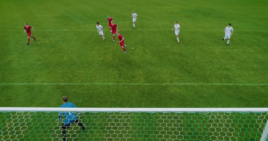 Soccer Player Receives Successful Pass, Kicks a Ball and Scores Amazing Goal doing Bicycle Kick, Goalkeeper Jumps but Fails to Save the Goals. Beautiful Aerial Shot Made from Behind the Goals. | Shutterstock HD Video #1019537980