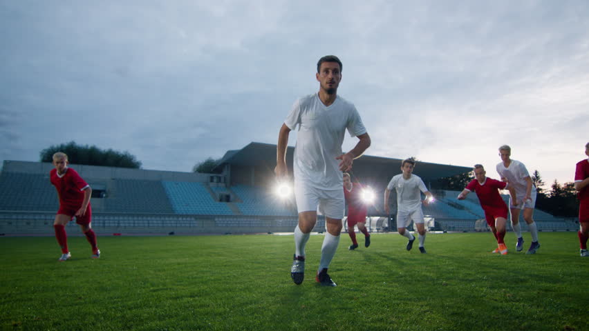 Professional Soccer Player Outruns Members of Opposing Team and Kicks Ball and Scores Goal. His Team Celebrates Victory. Cinematic Slow Motion. Royalty-Free Stock Footage #1019538163
