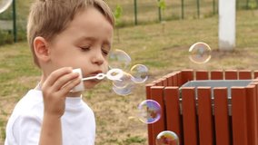 Happy child blowing soap bubbles in slow motion, close-up. - Powered by Shutterstock - Get 15% off with code: PIKWIZARD15