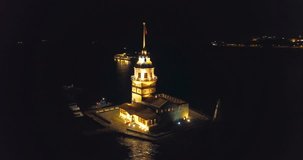 Istanbul Maidens Tower at night. 1 minute long aerial camera turning around the lighthouse. Kizkulesi
